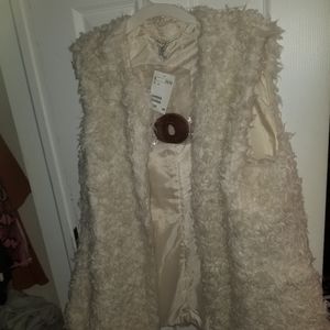 White Faux fur vest with brown belt.